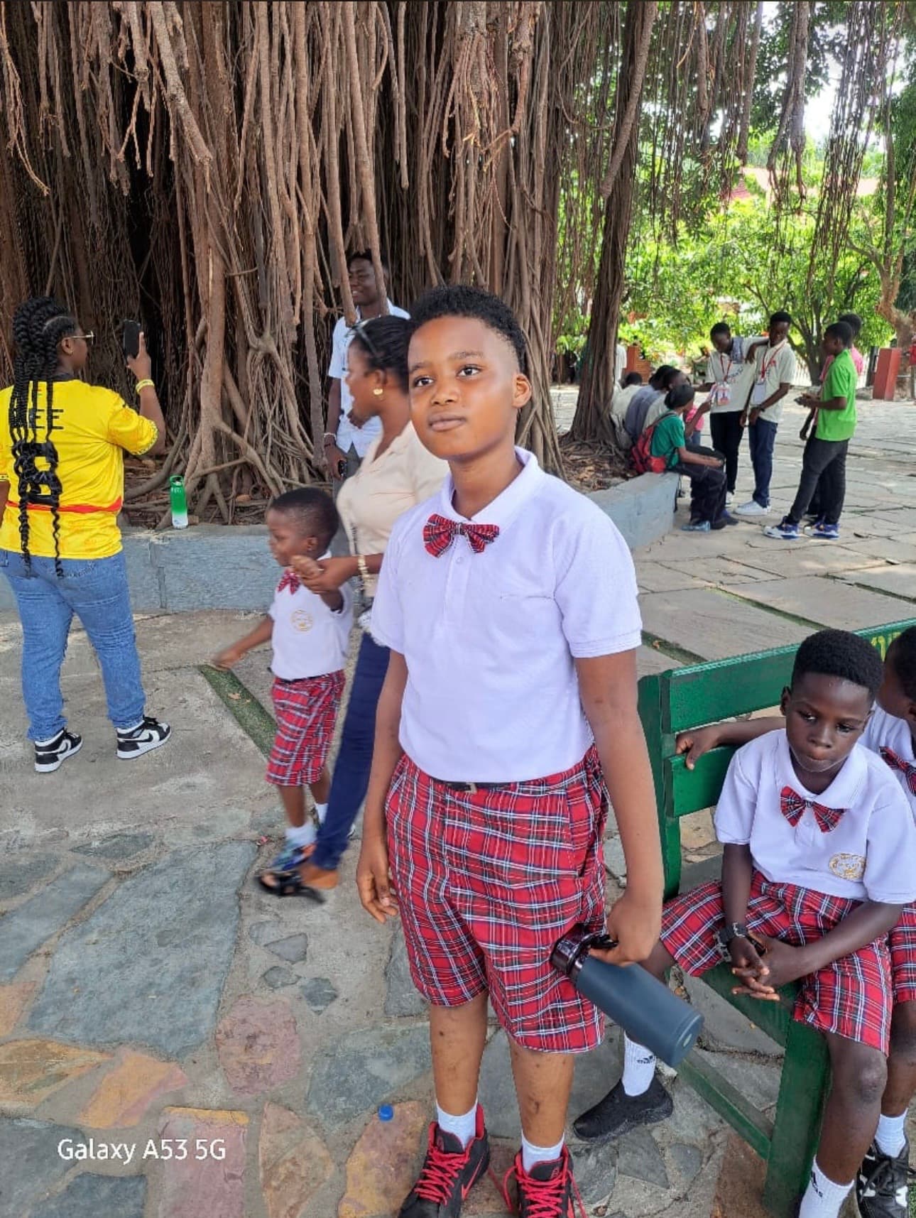 Student at field trip by large tree
