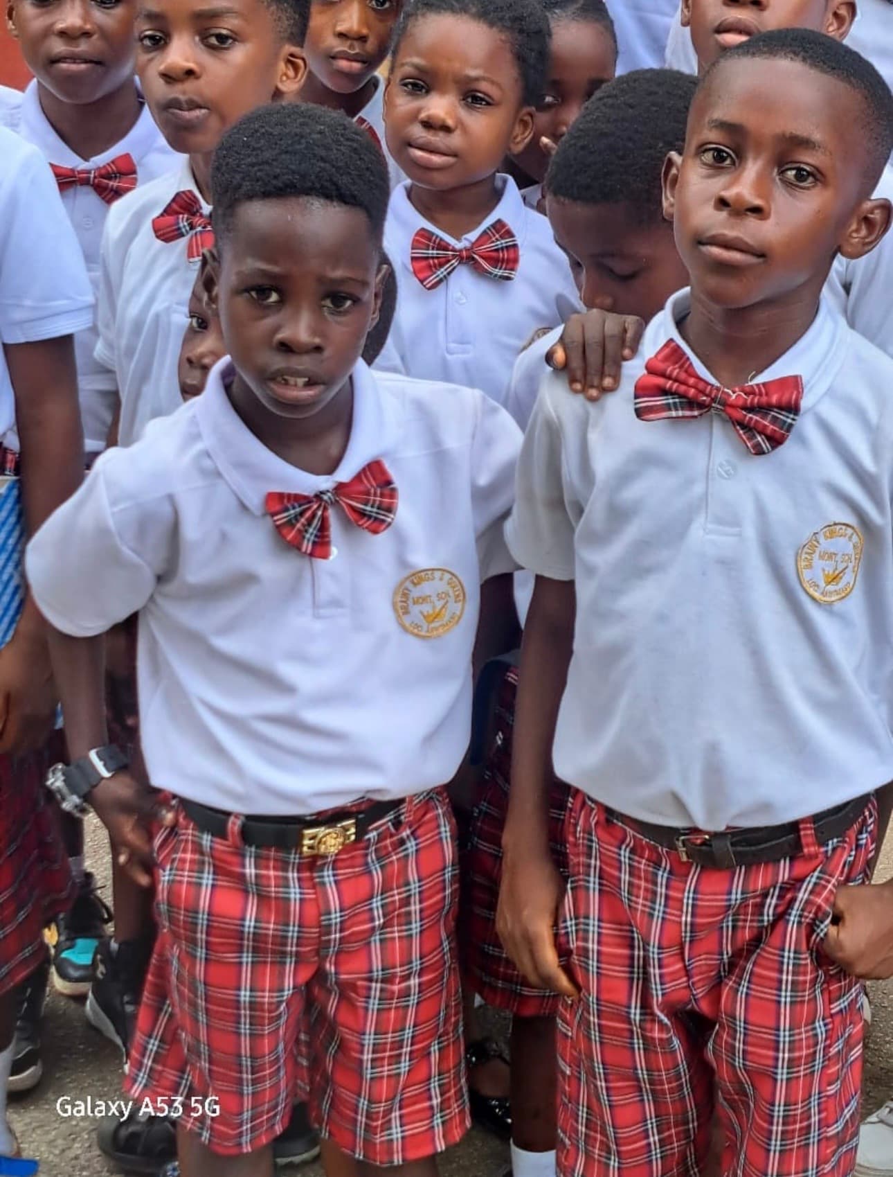 Students proudly showing school badges